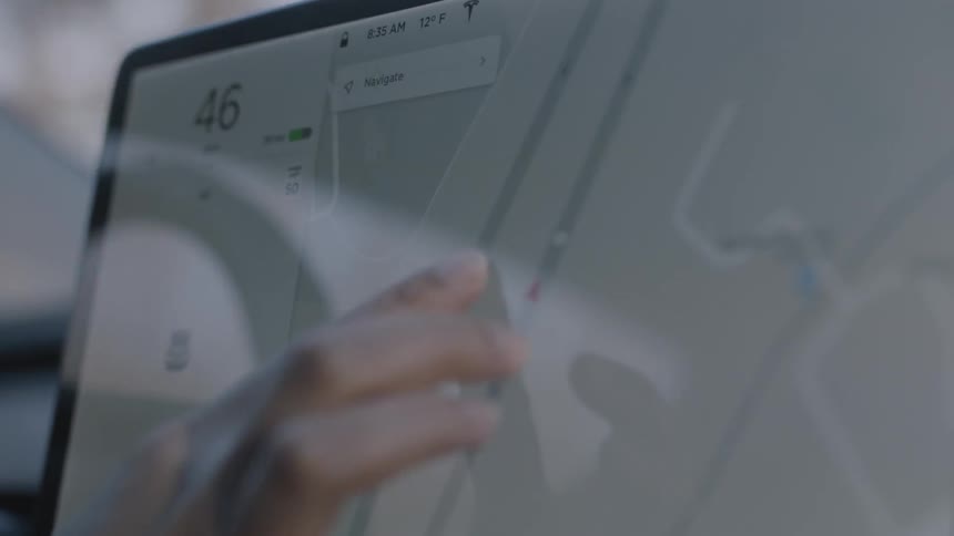 Person touches a touchscreen with a map on it