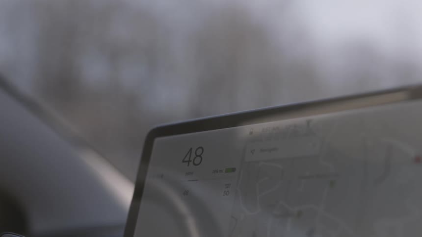 A gps screen on a dashboard as a car travels