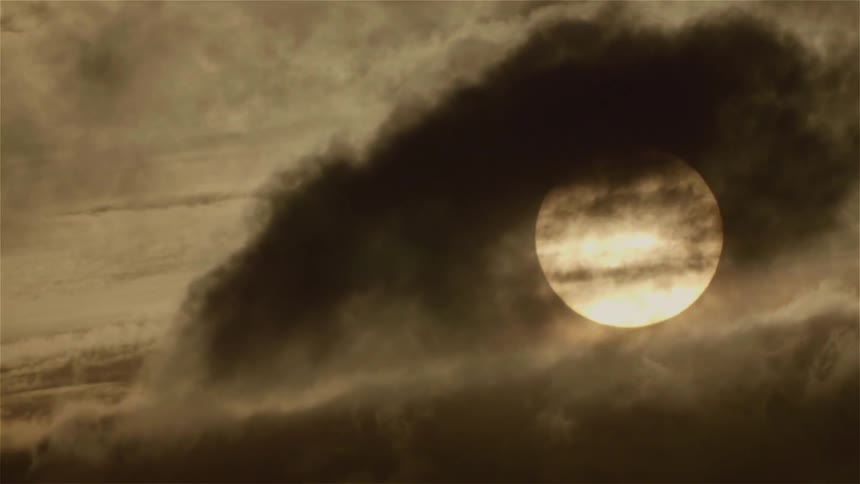 Clouds float in front of the moon