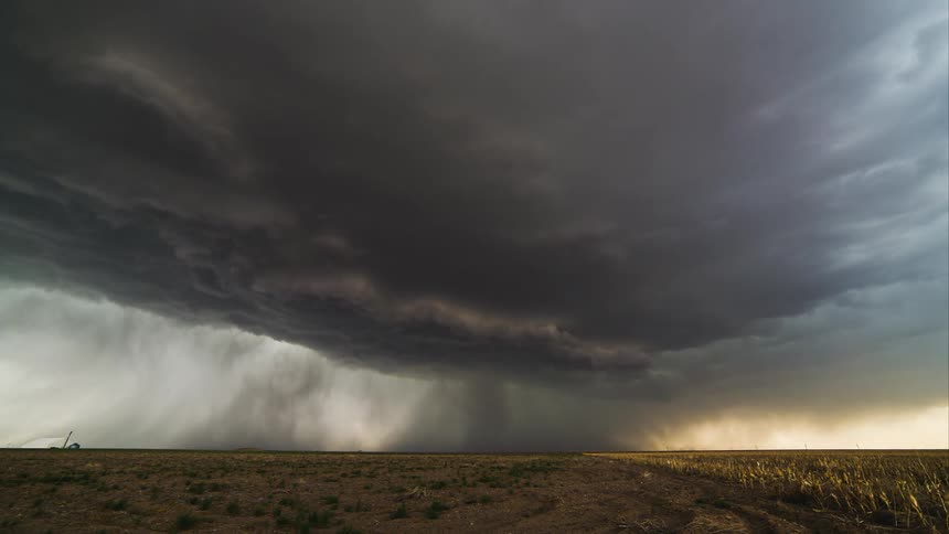 A storm is shown in timelapse over farmland