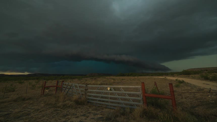 Time lapse of a farm with a storm forming up ahead