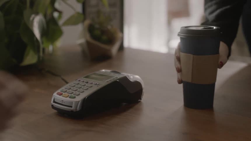 Coffee is served to a person after they pay with their phone