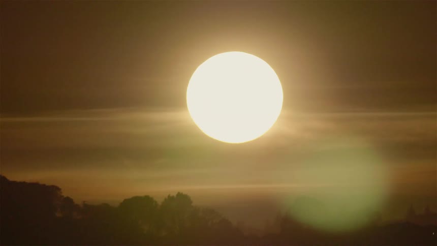 The clouds move over the sun at dawn