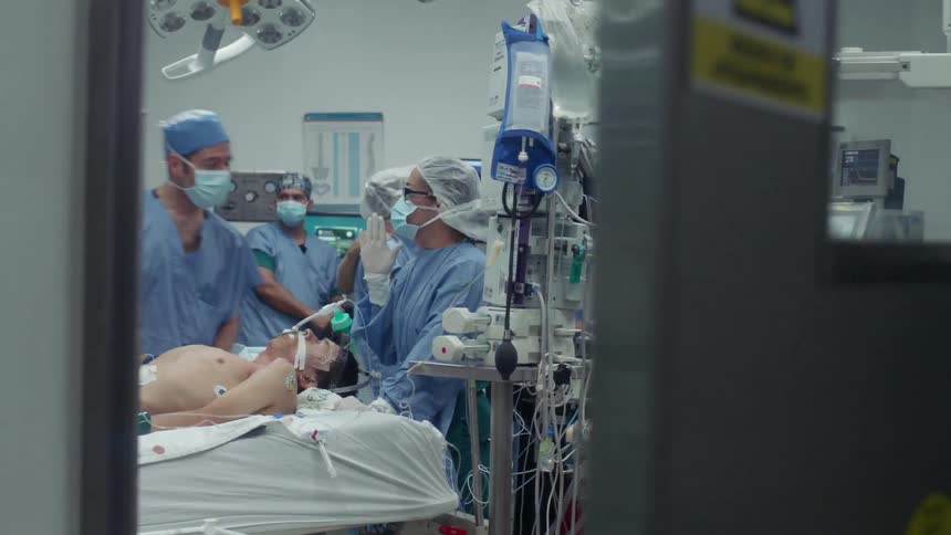 Doctors prepare to operate on a patient in the operating room