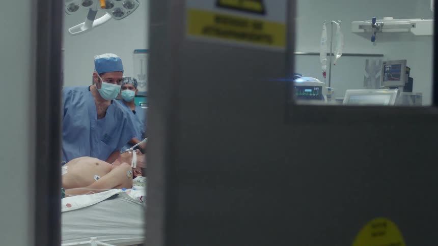 The doctors work on a patient in the operating room
