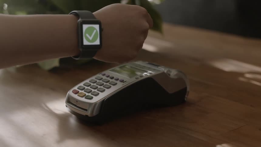 A man makes a payment with his smartwatch