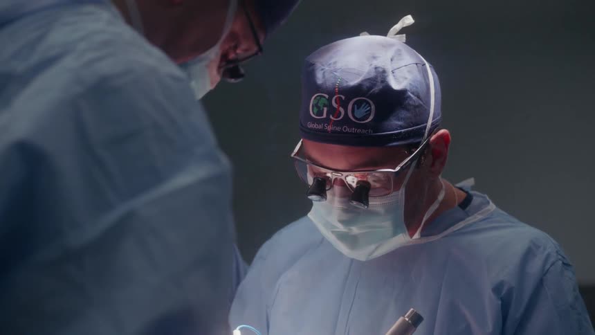 A surgical team is operating on a patient in an operating room