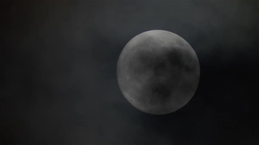 The full moon fills the dark sky