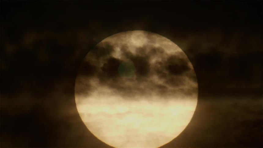 Clouds pass in front of a full moon