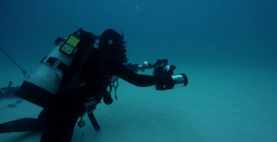 A diver films while swimming in the ocean