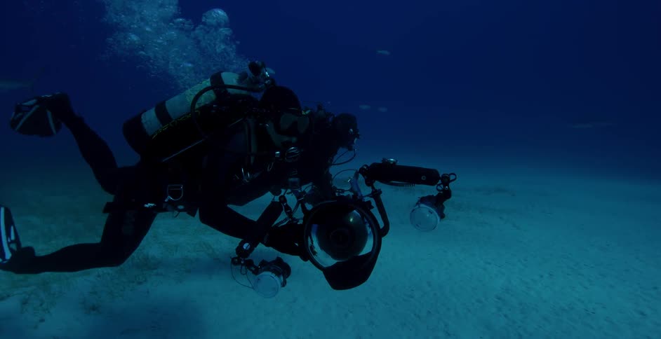Deep sea diver swims along the surface of the ocean