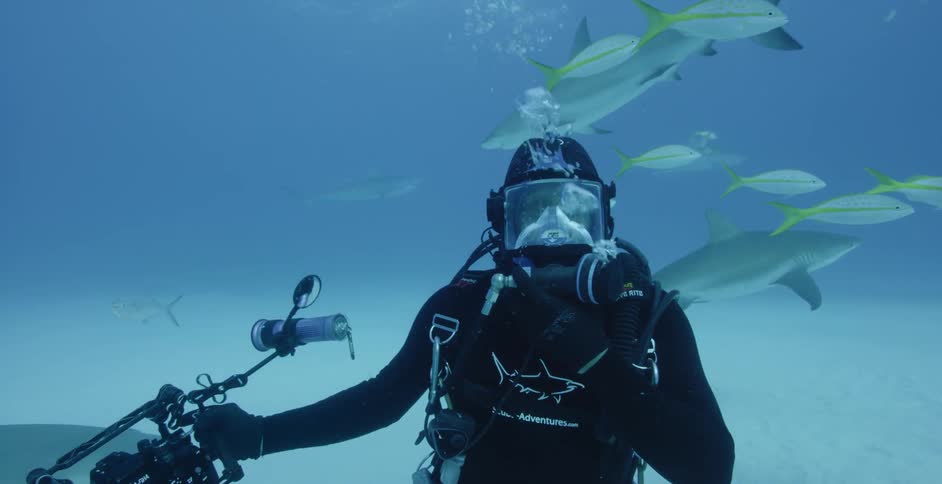 Diver holds camera and blows out bubbles