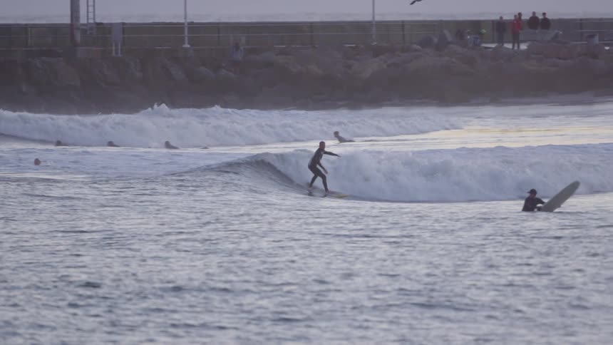 A surfer rides an ocean wave