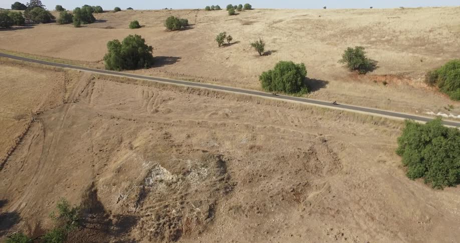 A car moves down the desert road on the hill