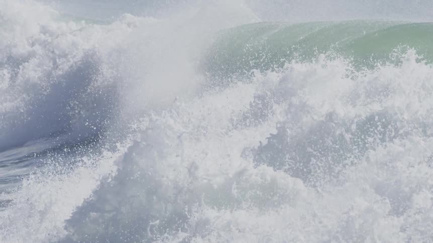 An ocean wave flows across the ocean