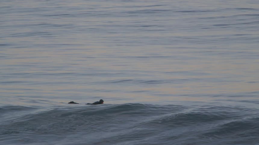 A man is floating in the waves