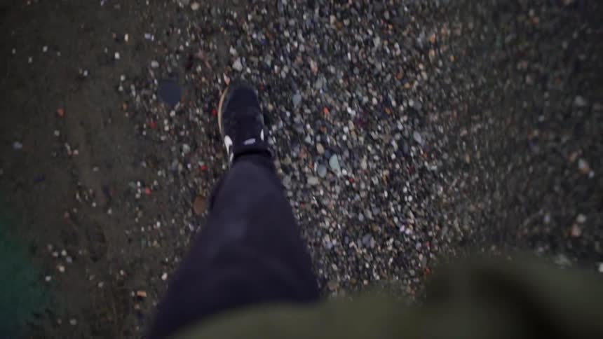 A person walks across dirt and rocks