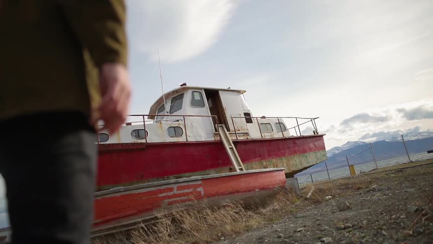 Person walks towards an abandoned shipwreck
