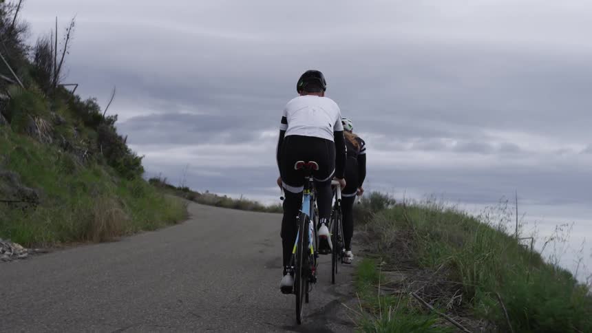 Two people are riding bikes outdoors