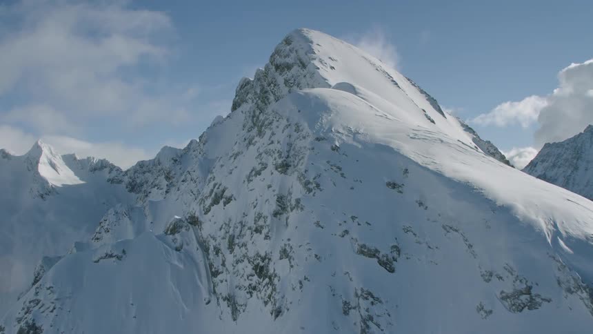 Passing over snow covered peaks on a sunny day