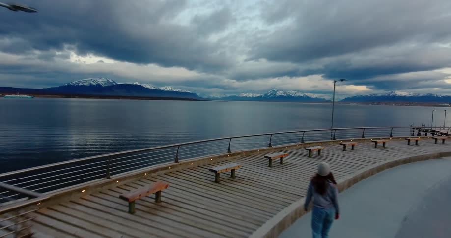 Person skates on a concrete ledge next to a large body of water