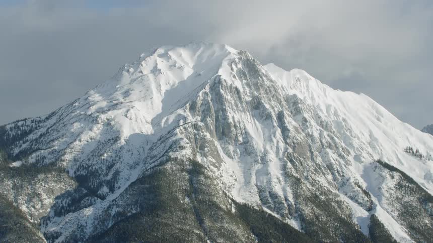 Snow covered mountains under a cloudy sky