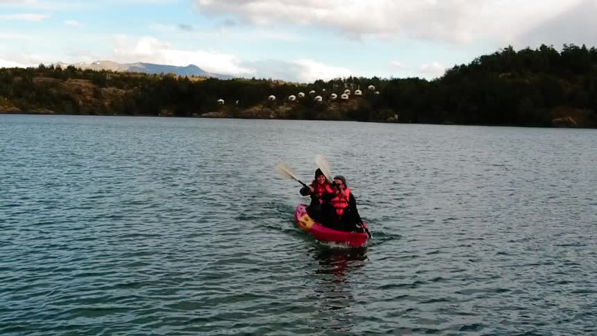 People kayak on a lake