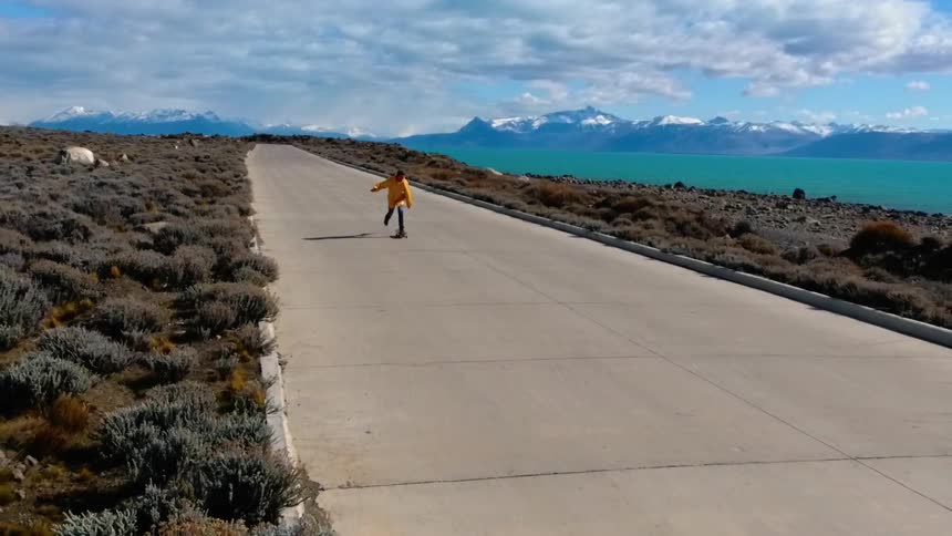 A skateboarder drops his board and jumps on