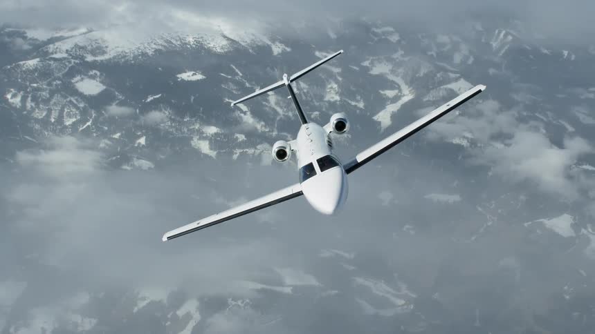 Jet flies above the mountains and mist