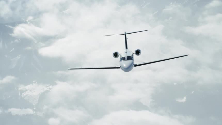 Airplane flies over the clouds on a sunny day