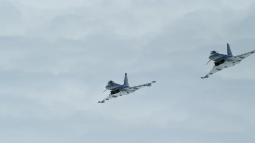 Fighter jets are flying above the clouds in daylight