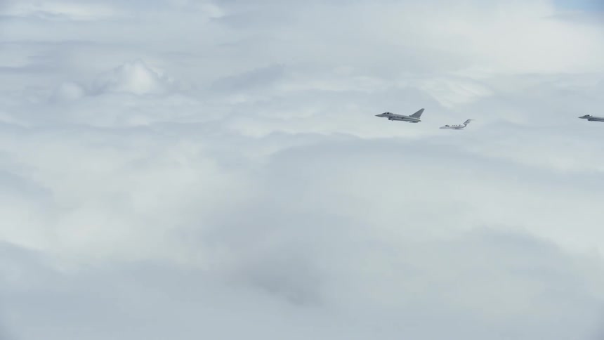 Jets fly in formation above the clouds
