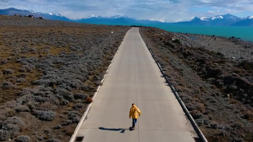 A skateboard travels up a  road