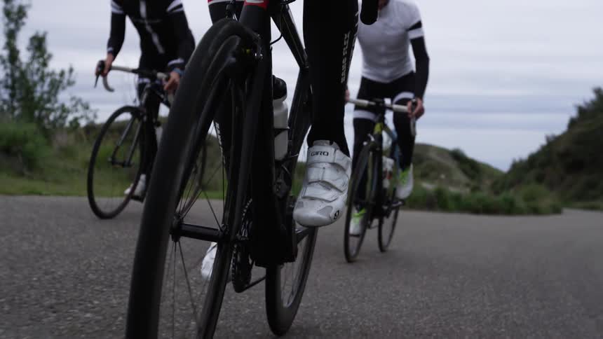 People ride bikes on an overcast day