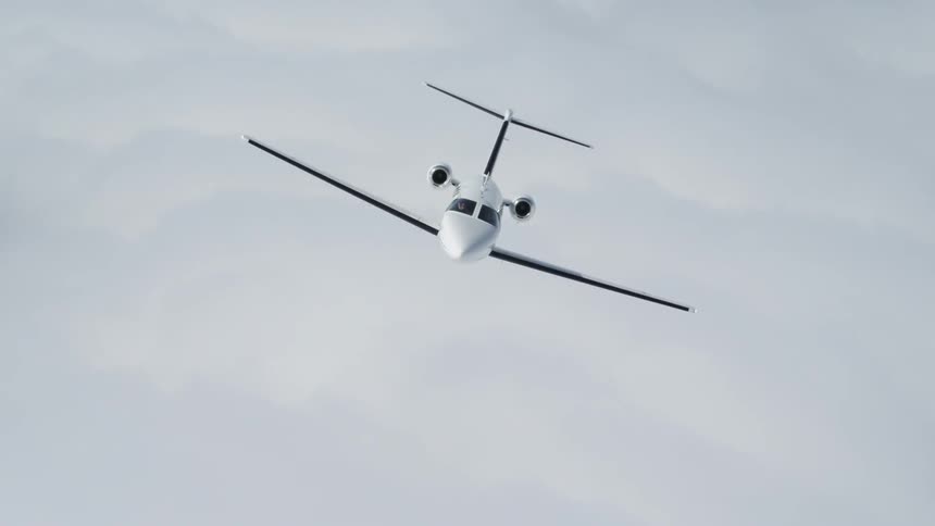 A luxury jet is flying above the clouds during the day
