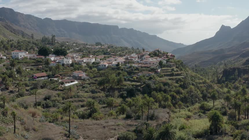 Houses sit on a hill in the mountains