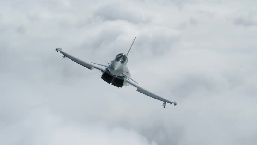 Fighter jet flies above the clouds