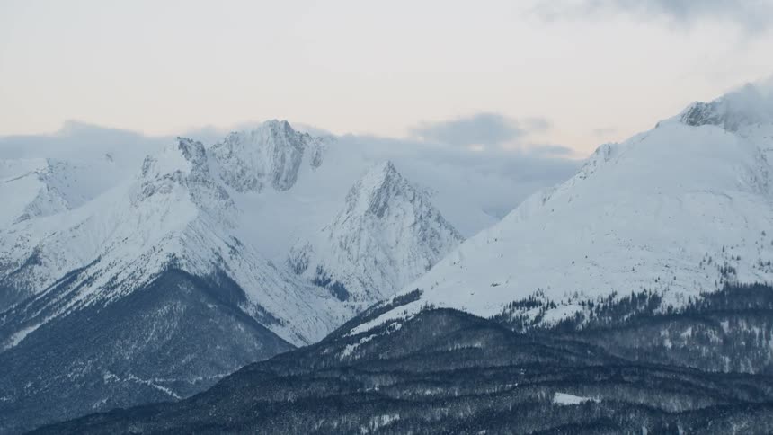 Snow covered mountains under a cloudy sky