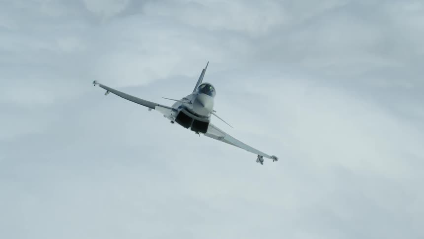 Fighter jet sways side to side above the clouds