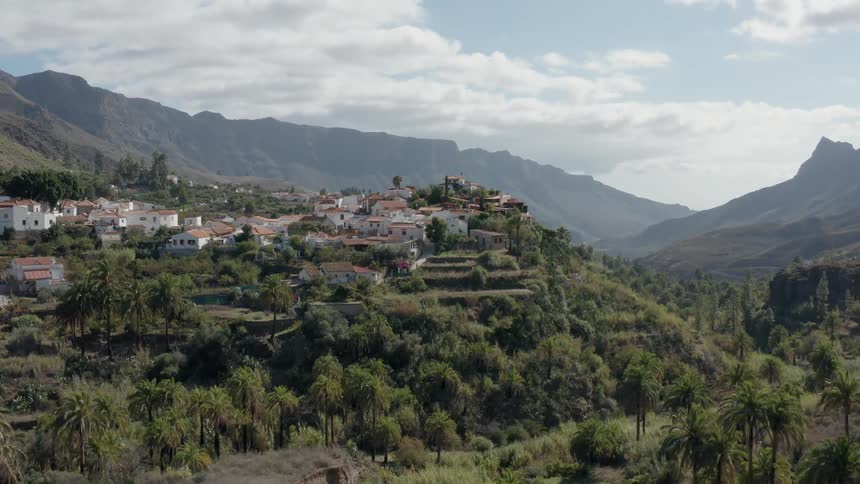 Houses sit on a hill in the mountains