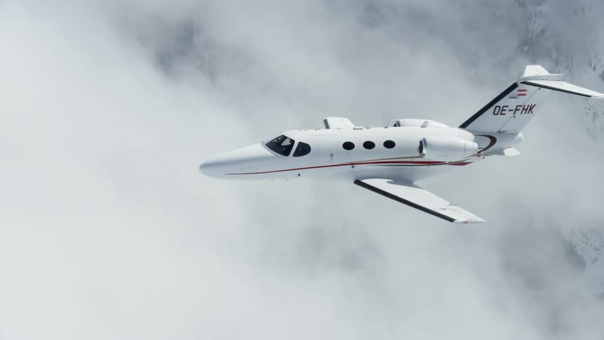 Airplane flying among billowy clouds