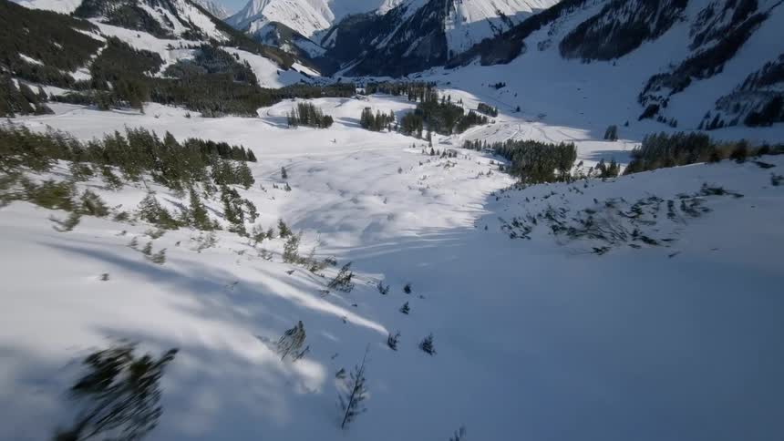 Snow covers mountains on a sunny day