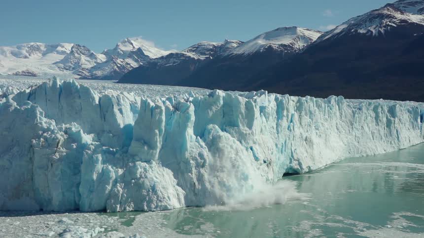 Ice falls off of a glacier into water