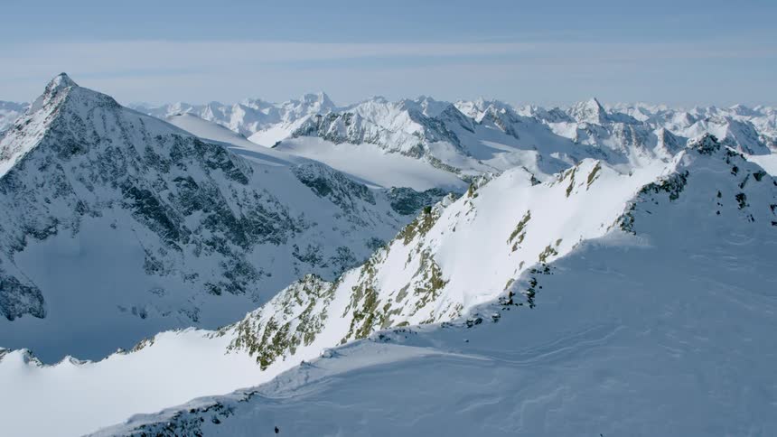 Passing over snow covered peaks on a sunny day