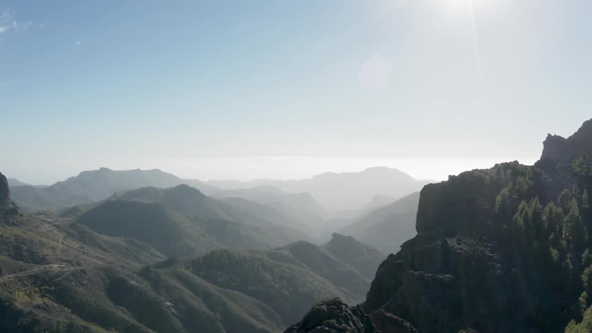The sun shines down on mountains