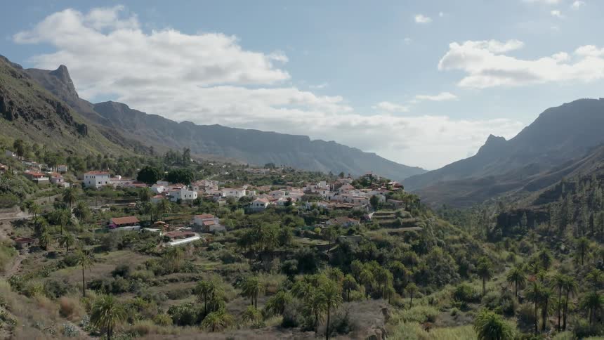 Houses sit on a hill in mountains