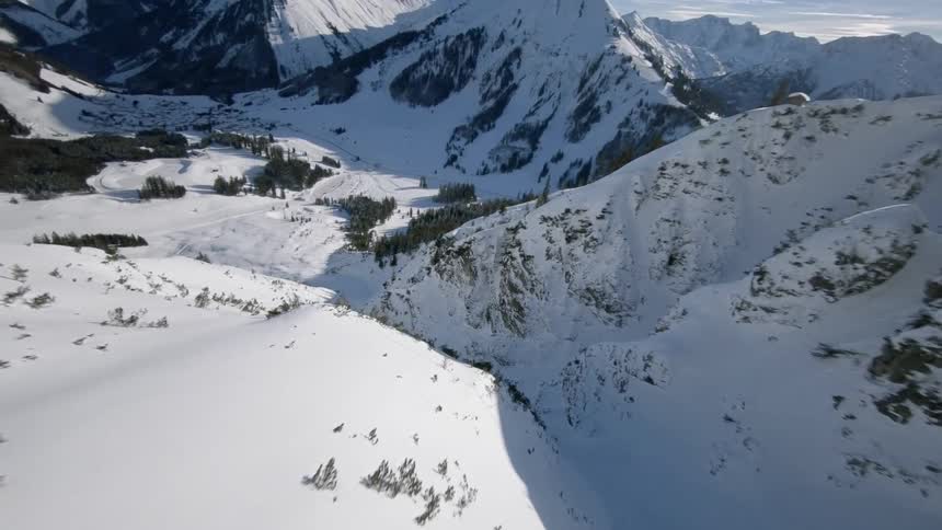 Snow covers mountains on a sunny day