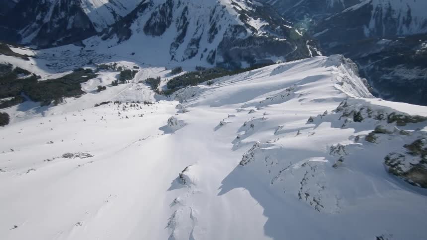 Snow covers mountains on a sunny day