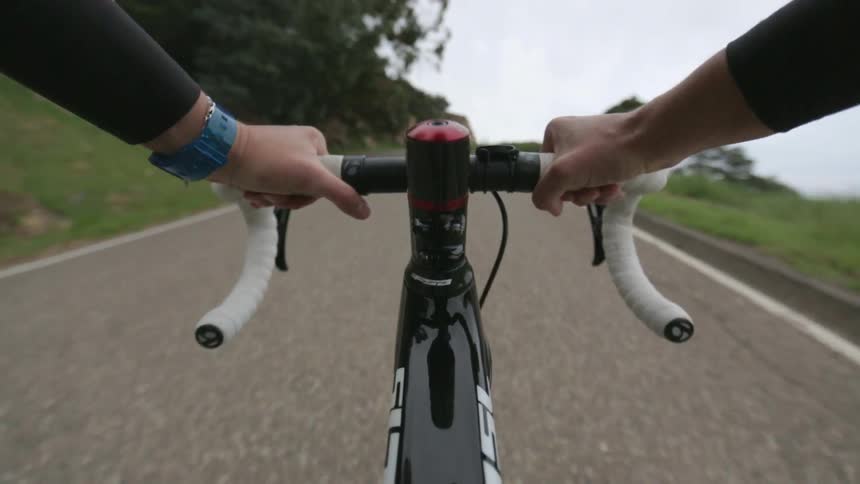 A biker is biking down a country road