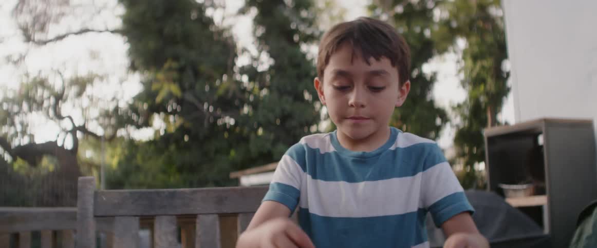 Children play outside in a backyard